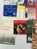 Grouped view of several stamp booklets and souvenir sheets showing designs and titles