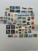 Full spread of approx 60 mint Canadian postage stamps