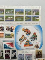 Close-up of top portion with 32¢ Historic Canals sheets and Winter Sports pane, plus assorted singles