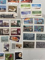 Overview of assorted mint Canadian postage stamps in blocks and singles
