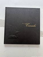 Front cover of black hardcover album with embossed loon and gold lettering