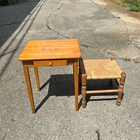 end table and rush bench side by side on pavement