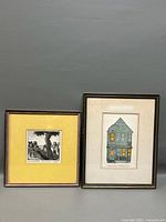 Both framed etchings side by side