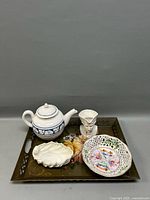 Group view of all porcelain pieces on floral tray