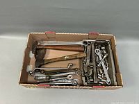 Overview of box showing hammers, wrenches, sockets