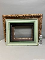 Three frames stacked; gold ornate front, green with black inner, brown/black with liner visible