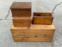 Four wooden boxes together on concrete surface