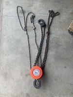 Full view of chain hoist with hooks and chains