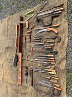 Full layout of 44 assorted antique hand tools on tarp
