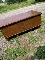 Front angled view showing carved decoration and bun feet