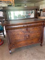 Front view showing full sideboard with mirror, drawers, doors and legs