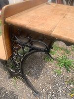 Cast-iron and wood school desk, side view showing ornate frame and wood seat/top