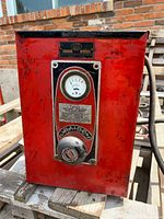 Front view showing ammeter, knob, red housing