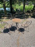 Table and two chairs set outdoors