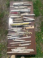 Full table view of approximately 40 folding rulers
