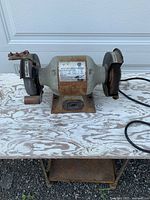 Full view of bench grinder on stand