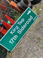 Full view of King Twp 17th Sideroad sign showing text, arrow, wear and mounting holes