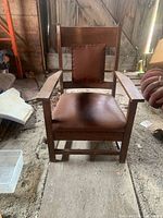 Front view of solid oak Arts and Crafts armchair with leather seat and back
