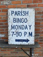 Front side of wooden sign showing text and right arrow