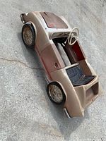 Left front angle showing body, seat, wheels, rust