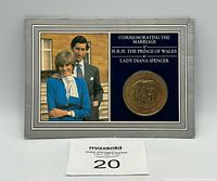Front of presentation card with coin and portrait of Prince Charles and Lady Diana