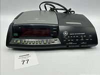 Front view showing GE digital CD clock radio, display, button array, attached power cord