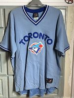 Front view of powder blue Toronto Blue Jays jersey showing lettering and logo