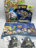 Group shot of both books, puzzle and two Buzz Lightyear zipper bags