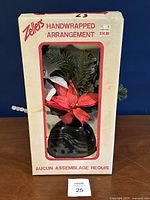 Front of boxed Zellers handwrapped arrangement showing contents through window