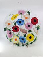 Front view of round glass plate with multicolor floral design