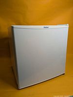 Front view of white Haier mini fridge