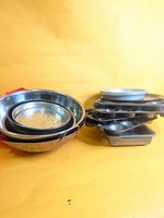 Group view showing stainless bowls, colanders and stacked bakeware