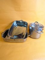 Group shot of both roaster pans, stockpot with lid and steamer insert