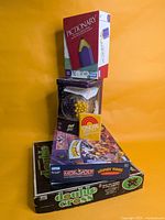 Stacked view showing all five boxed games