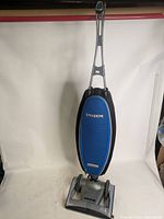 Full front view of Oreck Magnesium upright vacuum showing blue bag and handle