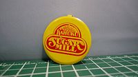 Front view of yellow Kahuku Sugar Mill pinback button