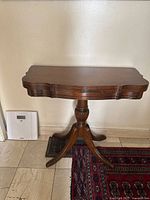 Card table closed, showing pedestal base and finish