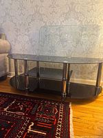 Front view showing three glass tiers and metal pillars