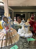 Front view showing both Royal Doulton figurines Daydreams and Marjorie on shelf