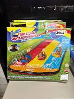 Front of boxed Jambo Triple Lane Water Splash Slide showing graphics and features