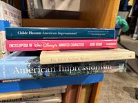 Stack of four art books showing titles on spines