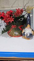 Overall view of artificial arrangement and painted gourd Santa