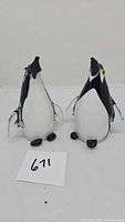 Front view of both glass penguin figurines