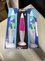 Front view of three Jambo Liquid Lamp boxes showing two blue-green and one pink-green units