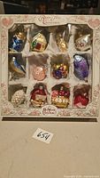 Front view of boxed set showing 12 ornaments in compartments