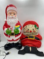 Front view of plastic Santa blow mold and fabric Santa pillow with separate feet piece