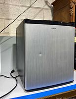 Front view of Culinair mini fridge showing brushed stainless door and dent