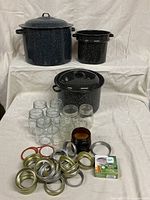 Group shot: three graniteware enamel pots, glass jars, rings, lids, Ball lid box
