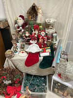 Overall view of lot with Santas, angel, carousel, stockings, wreath, lights, candles, dish, ornaments