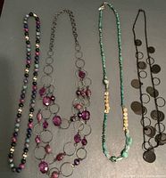 Four necklaces, multicolour beads, open ring & purple beads, turquoise chip, black disc dangle